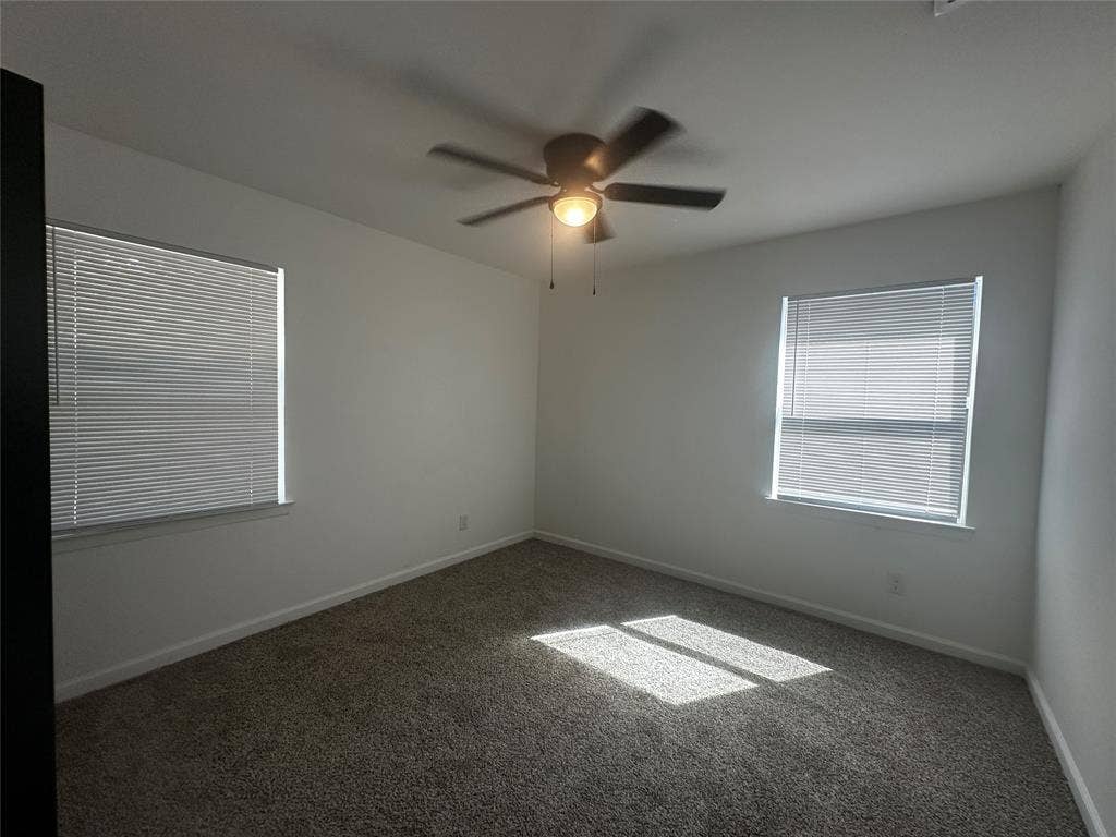 4808 Sandra Lynn Drive, Mesquite, TX 75150 Neutral-toned carpeted flooring, dual windows with fitted blinds, and an integrated ceiling fan with light fixture