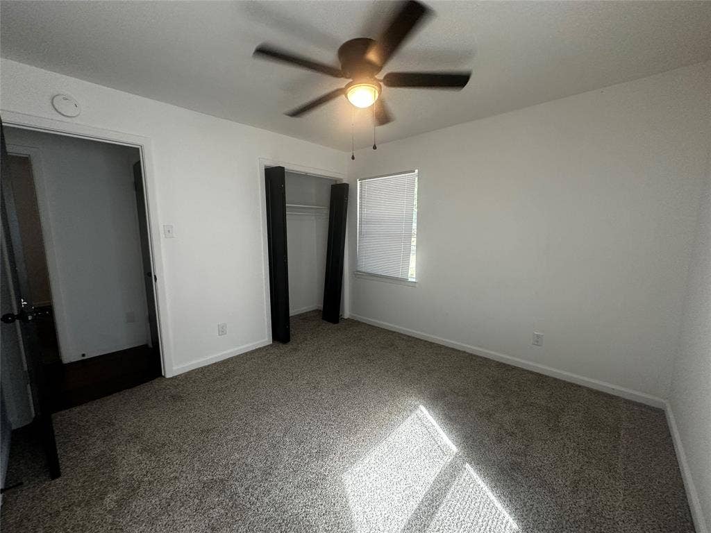4808 Sandra Lynn Drive, Mesquite, TX 75150 Neutral-toned carpeting, ceiling-mounted light fixture with fan, and closet with built-in shelving
