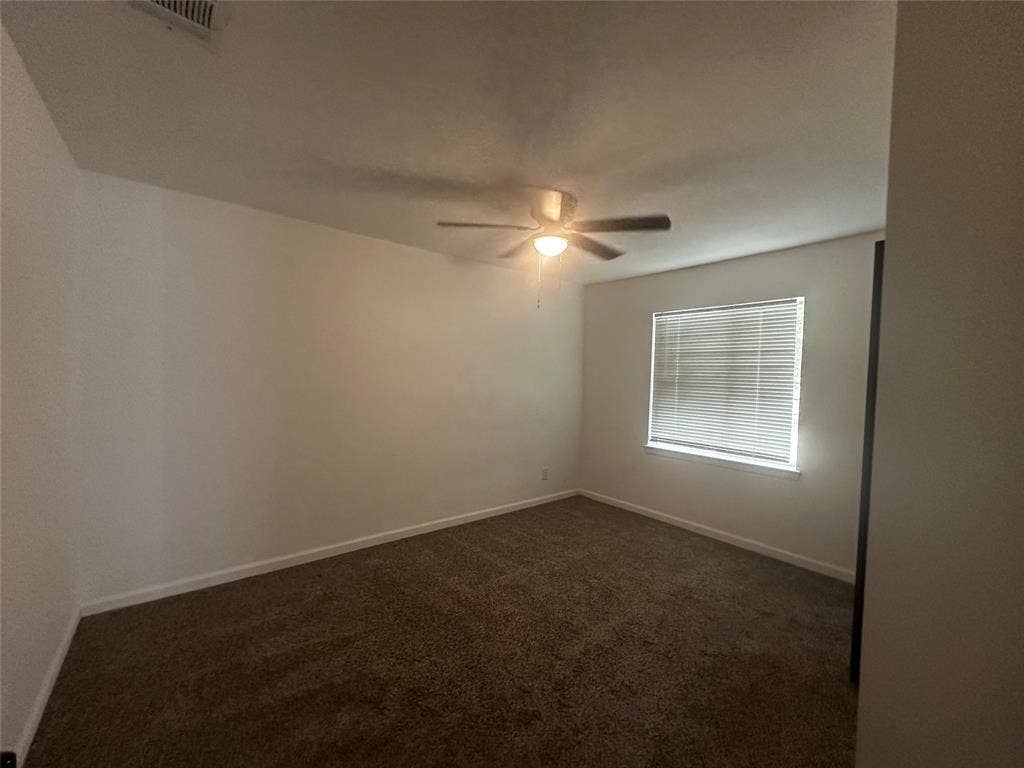 4808 Sandra Lynn Drive, Mesquite, TX 75150 Neutral interior space featuring carpeted flooring, a ceiling fan with integrated lighting, and horizontal window blinds