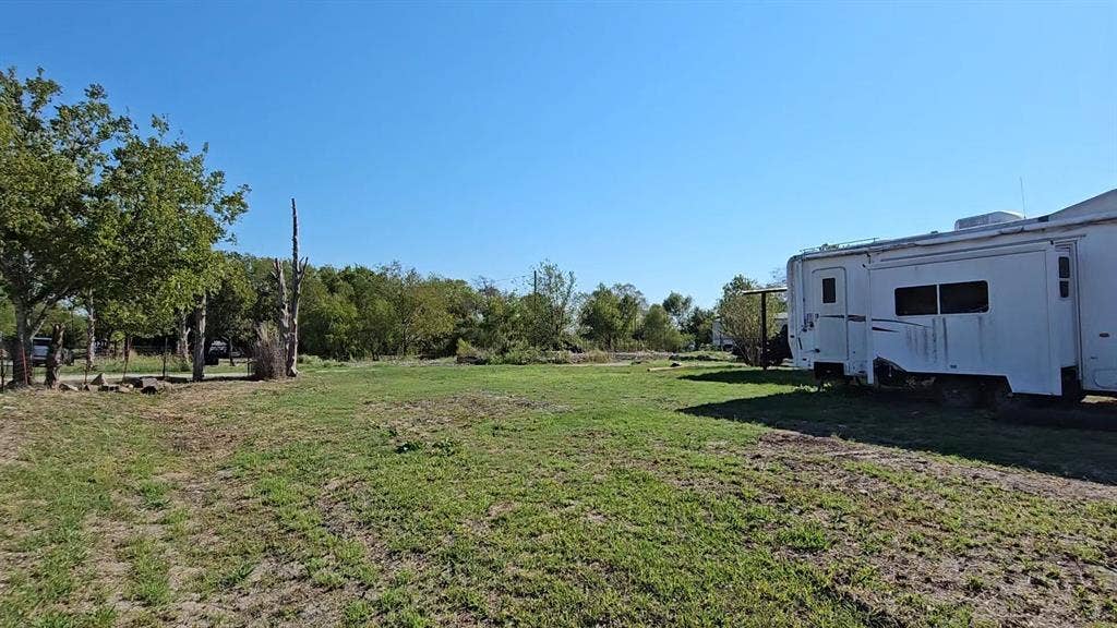 Expansive lot featuring mature trees, cleared land, and open green space
