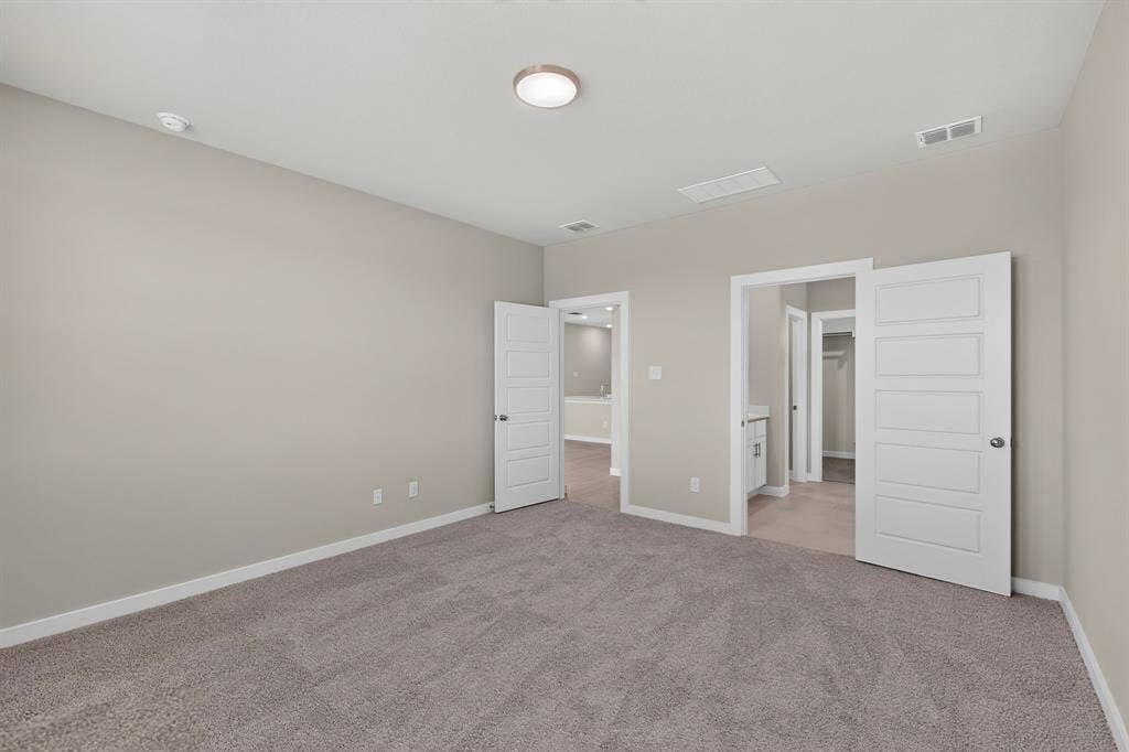 6001 Kaitlynn Drive, Princeton, TX 75071 Neutral-toned interior featuring wall-to-wall carpeting, five-panel interior doors, and a central ceiling-mounted flush light fixture