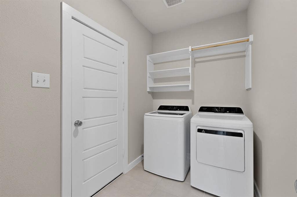 6001 Kaitlynn Drive, Princeton, TX 75071 Neutral-toned space featuring ceramic tile flooring, a solid-core four-panel door, and white built-in shelving with an integrated clothes rod