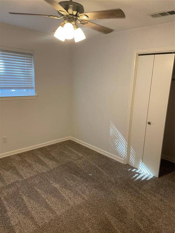 1423 Northridge Drive, Carrollton, TX 75006 Neutral-toned carpeting, ceiling-mounted light fixture with a fan, and white bifold closet doors