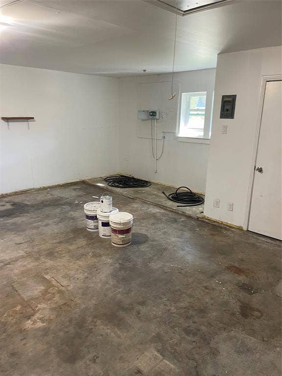 1423 Northridge Drive, Carrollton, TX 75006 Interior space featuring white-painted walls, concrete flooring, a single window, and a built-in wall shelf