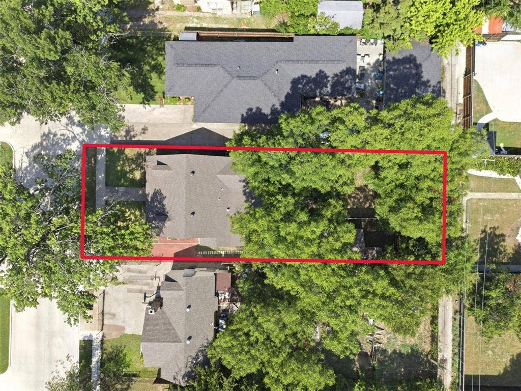 1227 Wilbur Street, Dallas, TX 75224 Aerial perspective of a residential lot featuring mature tree canopy, grass lawn, and paved walkway