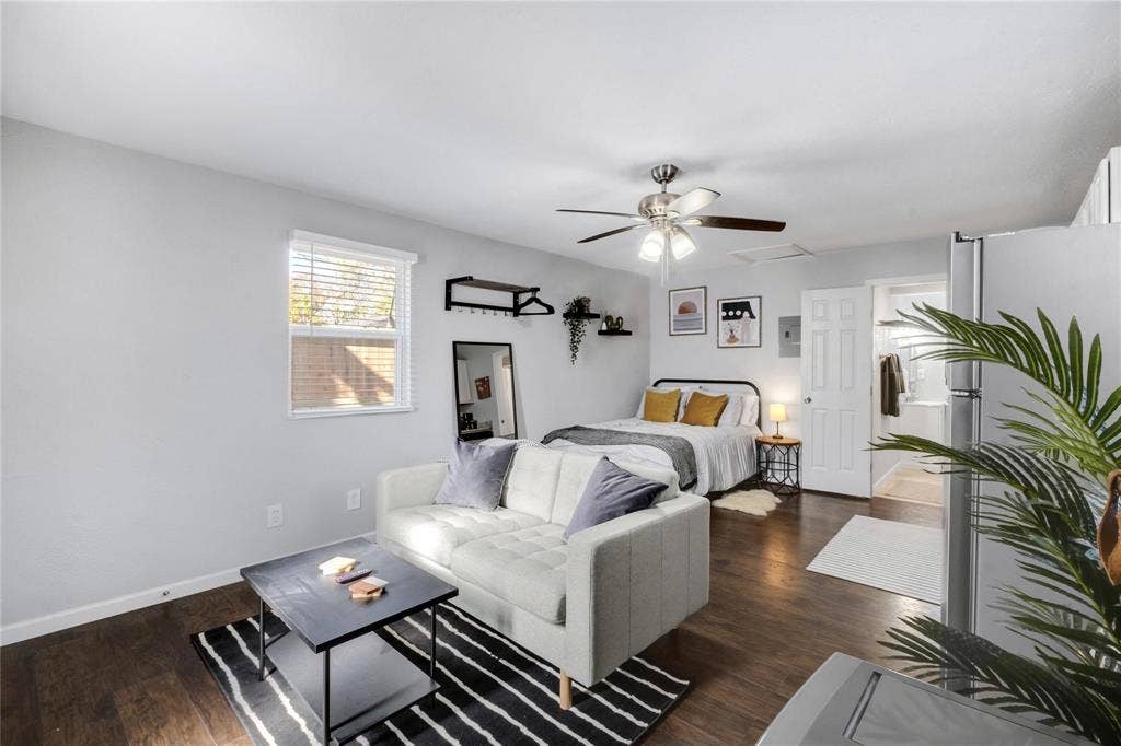 1227 Wilbur Street, Dallas, TX 75224 Wood-finish flooring, multi-blade ceiling fan with integrated lighting, and white six-panel interior door