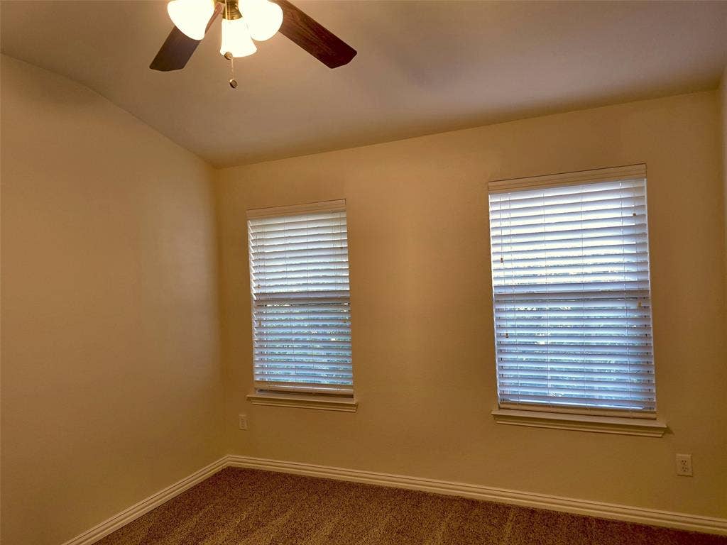 1504 Fox Run Drive, Irving, TX 75063 Room with neutral wall color, dual windows featuring horizontal blinds, and a ceiling fan