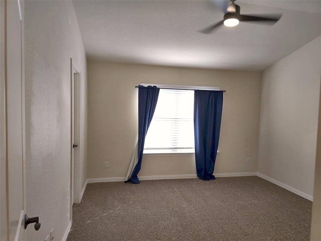 1504 Fox Run Drive, Irving, TX 75063 Neutral-toned room featuring high vaulted ceilings, wall-to-wall carpeting, and a ceiling-mounted light fixture with integrated fan