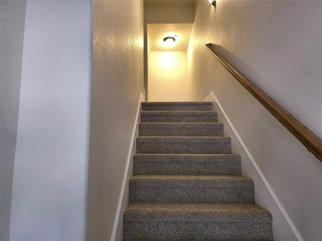1504 Fox Run Drive, Irving, TX 75063 Staircase featuring wall-to-wall carpeting, wood-finish handrail, and integrated ceiling lighting