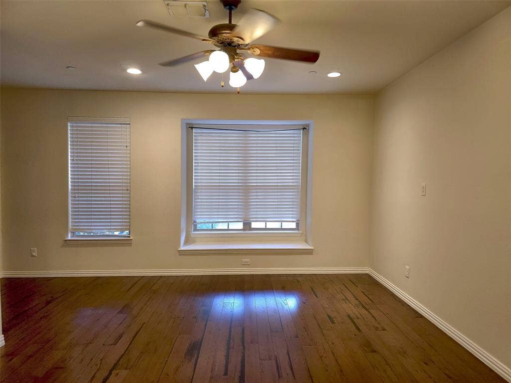 1504 Fox Run Drive, Irving, TX 75063 Wood-finish flooring, recessed lighting, multi-blade ceiling fan with integrated light fixture, window seat, and horizontal blinds