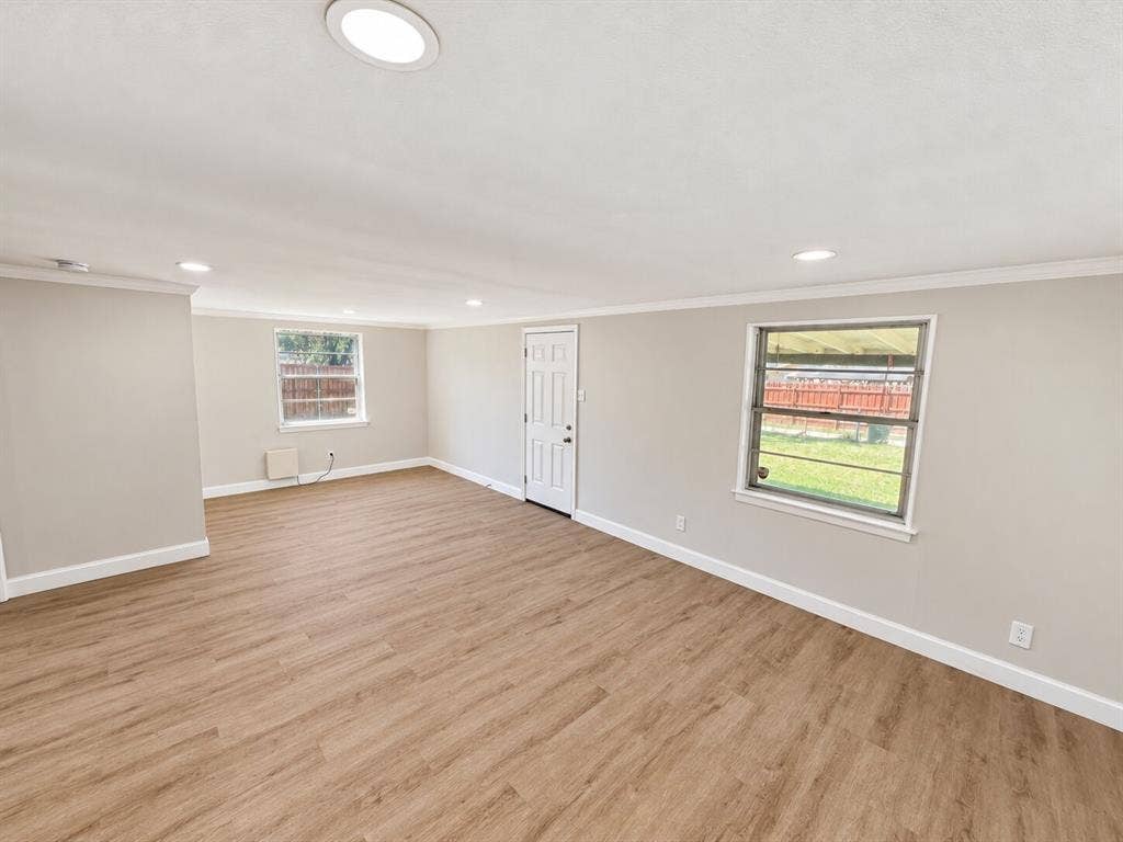 1307 Crestridge Drive, Plano, TX 75075 Spacious room featuring wood-finish flooring, recessed lighting, crown molding, and dual windows