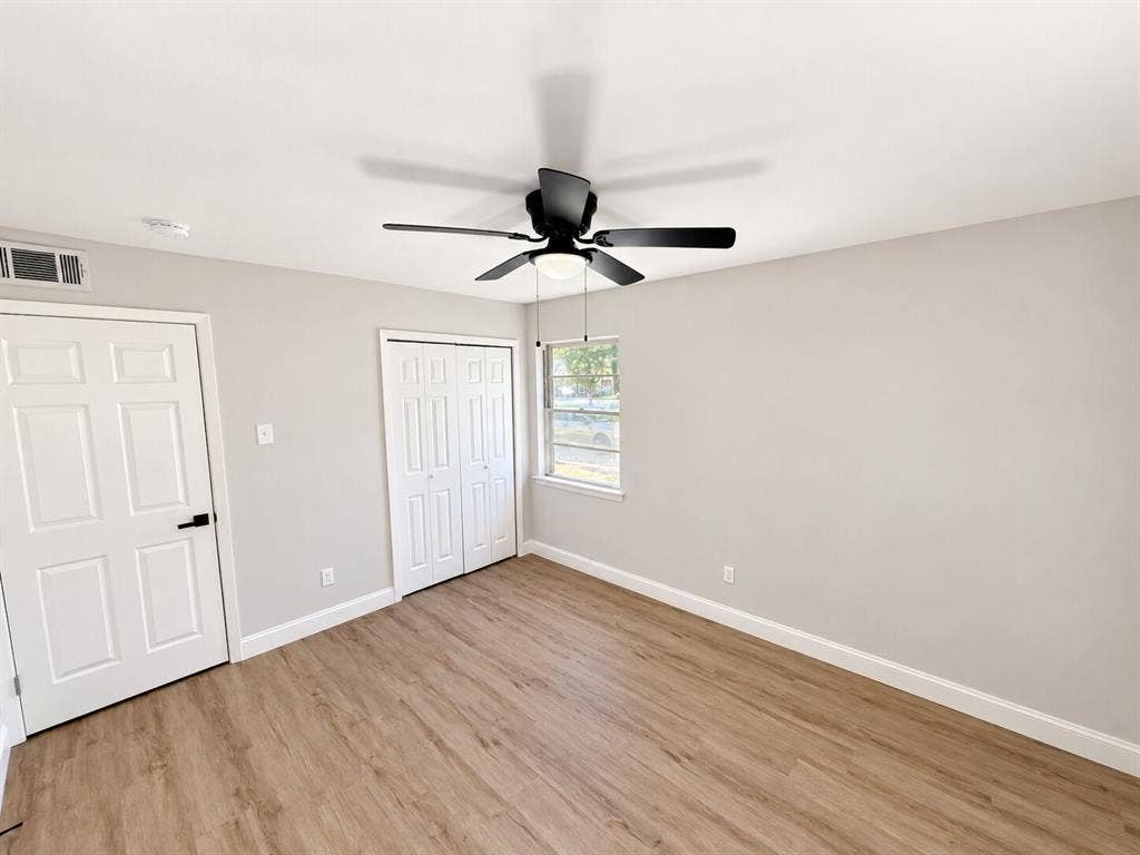 1307 Crestridge Drive, Plano, TX 75075 Wood-finish flooring, neutral wall tones, multi-panel doors, and a ceiling fan with integrated lighting