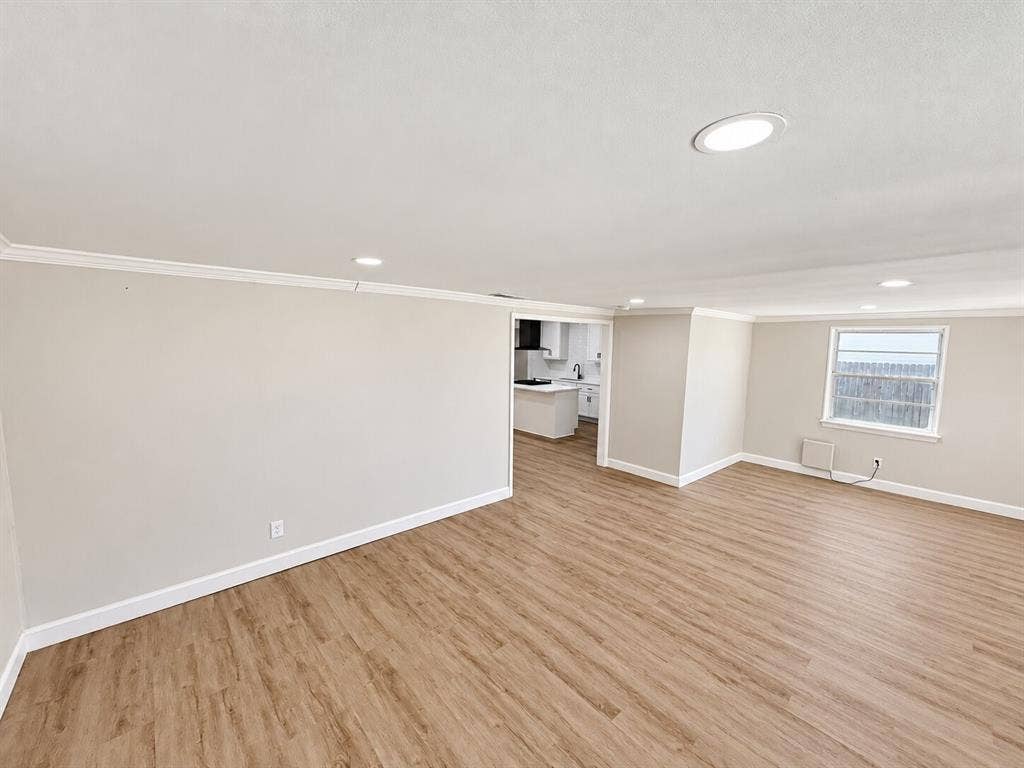 1307 Crestridge Drive, Plano, TX 75075 Open interior space featuring wood-finish flooring, recessed lighting, neutral wall paint, and crown molding