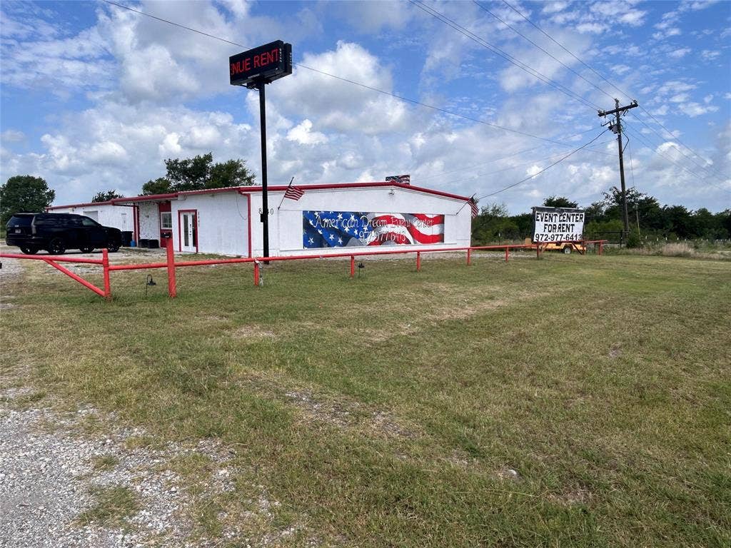 8440 E Highway 175 Highway, Kemp, TX 75143 Single-story commercial building featuring a metal facade, gravel parking area, expansive open grounds, and a pole-mounted signage structure