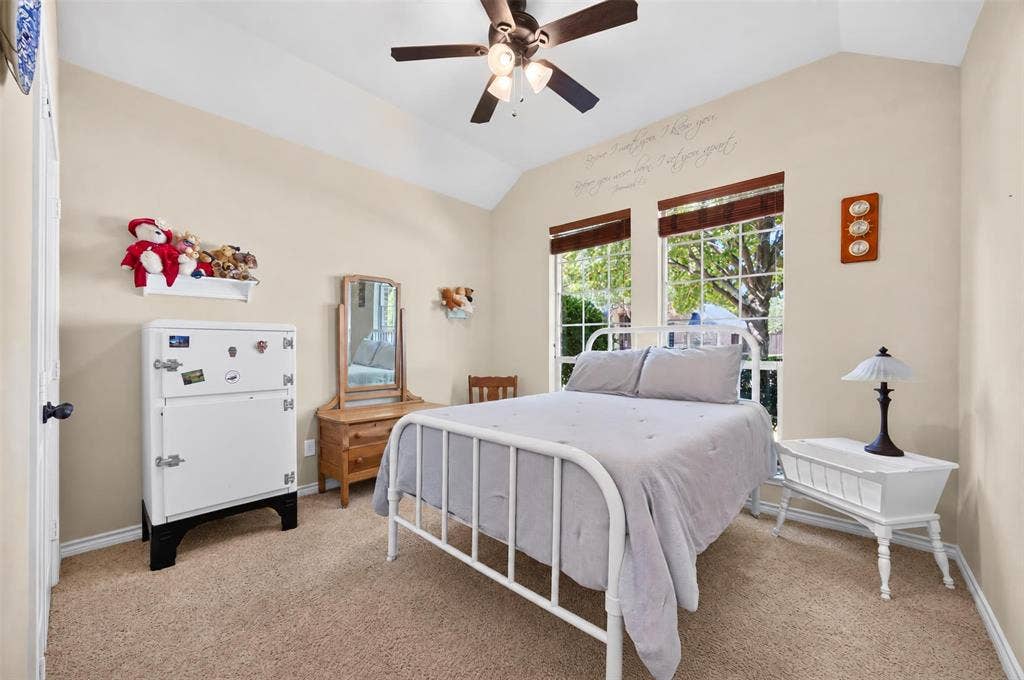 1514 Natalie Lane, Duncanville, TX 75137 Vaulted ceiling with an integrated three-blade ceiling fan and light fixture, featuring dual multi-pane windows with wood-finish blinds