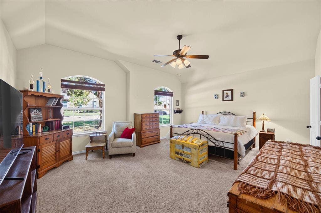 1514 Natalie Lane, Duncanville, TX 75137 Vaulted ceilings, carpeting, dual arched windows, and a ceiling fan with integrated lighting