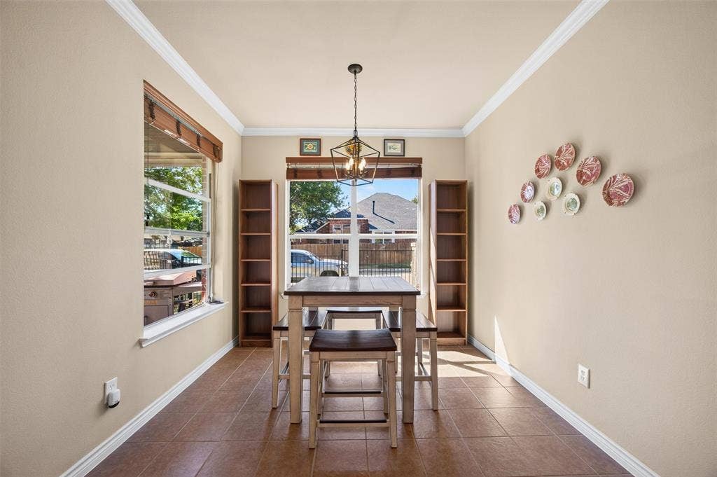 1514 Natalie Lane, Duncanville, TX 75137 Tile flooring, crown molding, built-in wooden shelving, dual windows, and an industrial-style geometric pendant light fixture