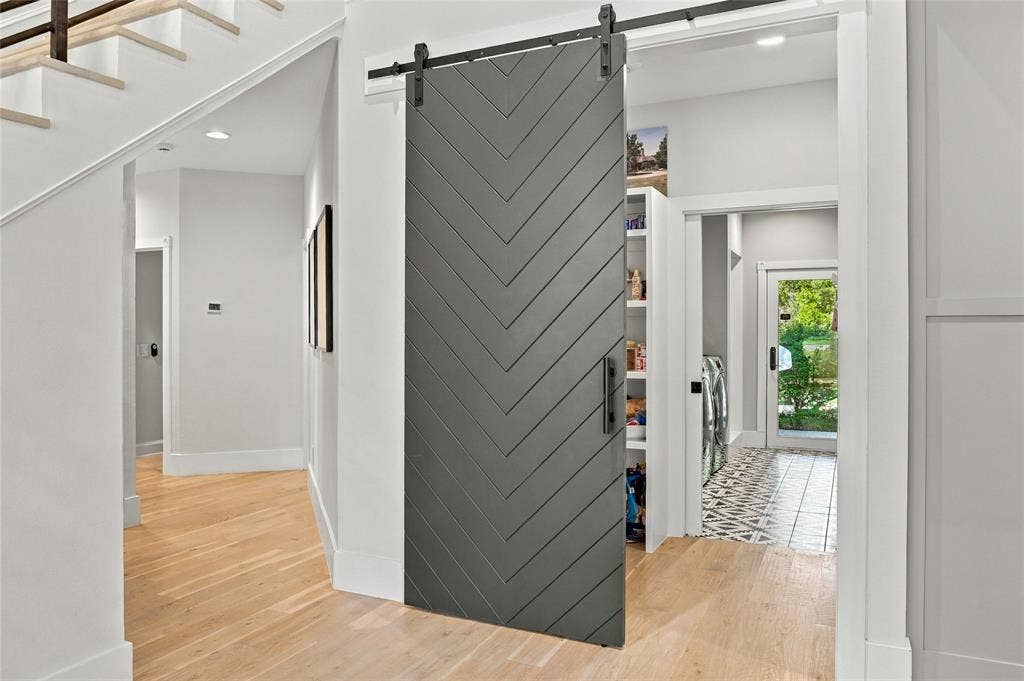 Large Walk-in Pantry which leads to separate laundry room including ice maker, dog shower, & door to exterior