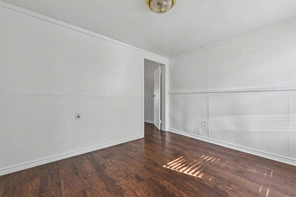 105 College Street, #107, Wylie, TX 75098 Interior space featuring wood-finish flooring, wainscoting-style wall paneling, and a flush-mount ceiling light fixture