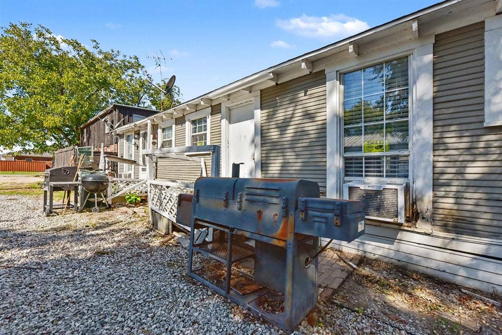105 College Street, #107, Wylie, TX 75098 Horizontal lap siding exterior with multi-pane windows and a gravel ground surface