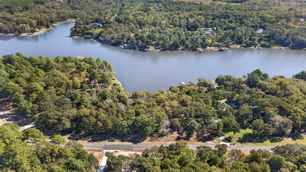 0 Safari Shores Drive, Larue, TX 75770 Aerial perspective of waterfront parcel featuring extensive shoreline, dense mature tree canopy, and direct road access
