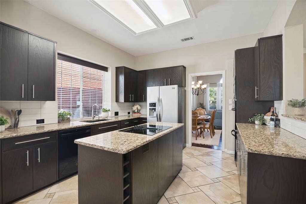 The kitchen combines granite countertops, double ovens.