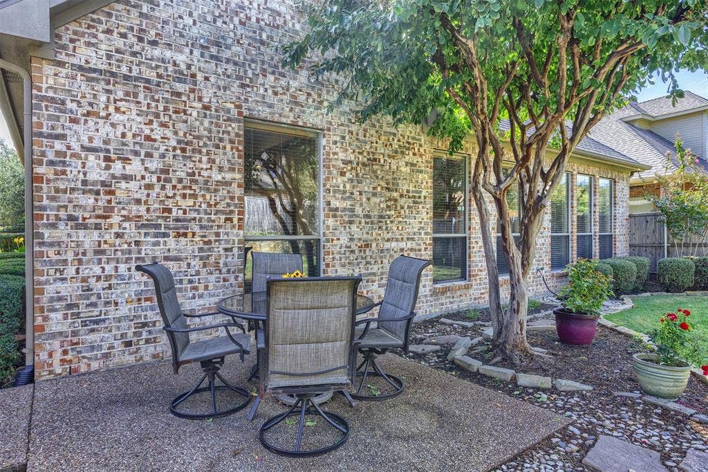 1516 Hackett Creek Drive, McKinney, TX 75072 Large backyard with shaded sitting area.