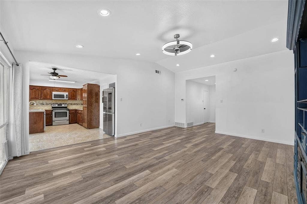 2130 Bowie Drive, Carrollton, TX 75006 Open-concept interior featuring wood-finish flooring, recessed lighting, and a modern ceiling fan