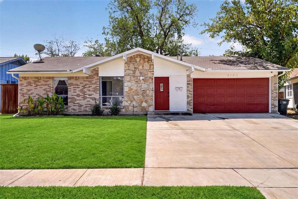 2130 Bowie Drive, Carrollton, TX 75006 Single-story exterior featuring a brick and stone facade, two-car garage, and concrete driveway