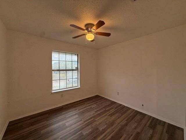 Room featuring wood-finish flooring, a multi-pane window, and a ceiling-mounted light fixture with an integrated fan