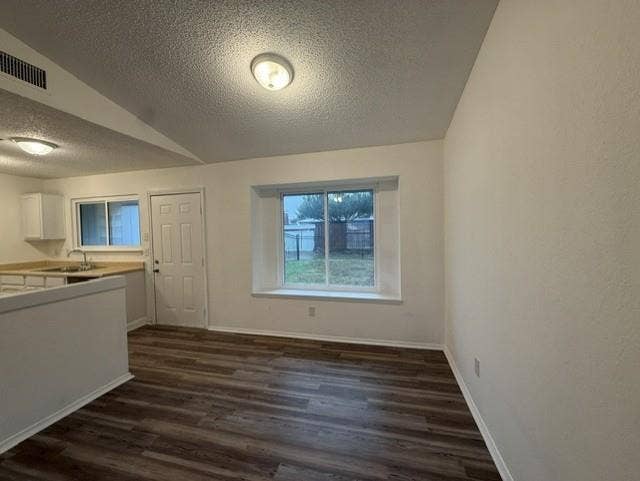 Wood-finish flooring, recessed lighting, and a prominent bay window with a wide sill
