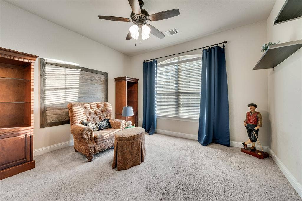 7231 Judy Drive, Ovilla, TX 75154 Room featuring high ceilings, wall-mounted wood shelving, built-in cabinetry, carpeted flooring, and a ceiling fan with integrated lighting
