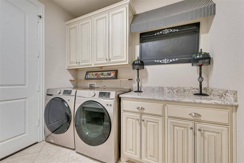 7231 Judy Drive, Ovilla, TX 75154 Laundry area featuring raised-panel cabinetry, light-toned stone-patterned countertops, and tile flooring