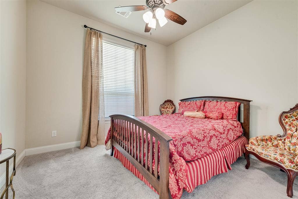 7231 Judy Drive, Ovilla, TX 75154 Neutral wall color, carpeted flooring, window with blinds, and a ceiling-mounted light fixture with fan
