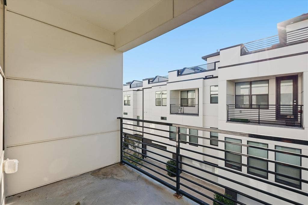 1813 Park Avenue, #106, Dallas, TX 75215 Covered balcony featuring horizontal metal railings and smooth panel exterior cladding