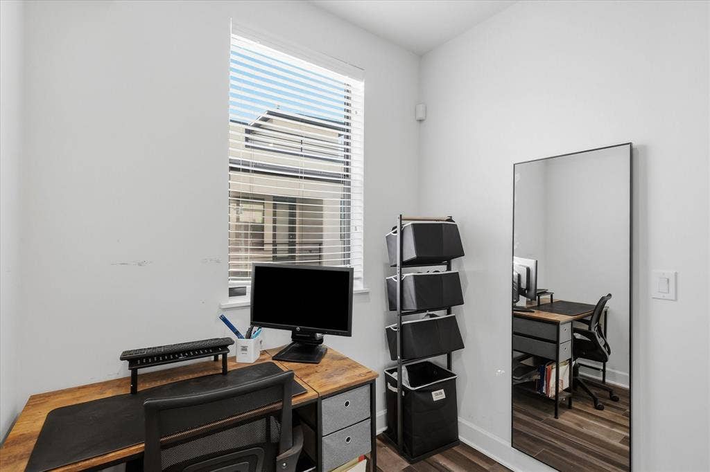 1813 Park Avenue, #106, Dallas, TX 75215 Room featuring a tall window with horizontal blinds and wood-finish flooring