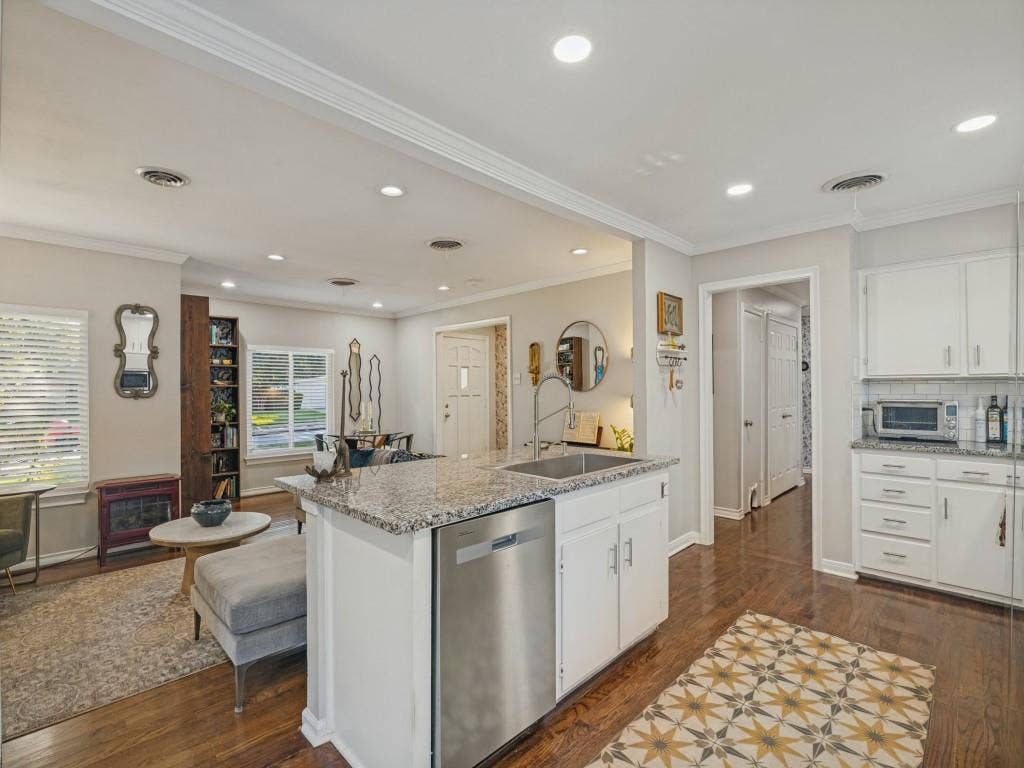 200 S Weatherred Drive, Richardson, TX 75080 Kitchen featuring an island with a stone countertop, an integrated stainless steel dishwasher, white shaker-style cabinetry, recessed lighting, and wood-finish flooring