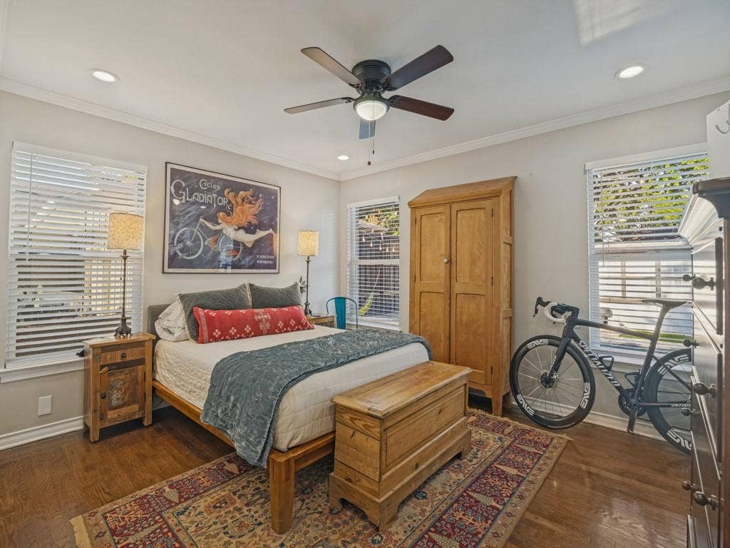 200 S Weatherred Drive, Richardson, TX 75080 Wood-finish flooring, recessed lighting, ceiling fan, and multiple windows with horizontal blinds