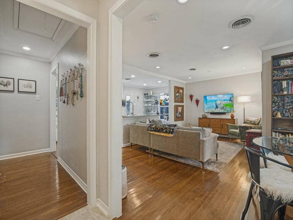 200 S Weatherred Drive, Richardson, TX 75080 Interior space featuring wood-finish flooring, recessed lighting, and built-in floor-to-ceiling shelving