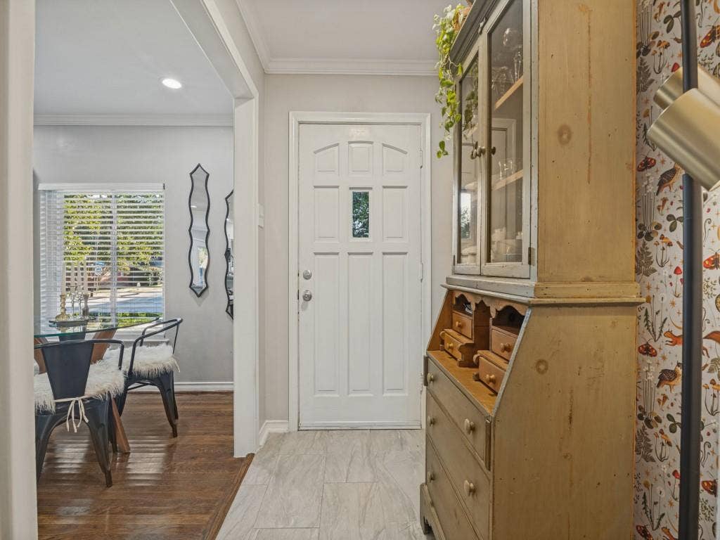 200 S Weatherred Drive, Richardson, TX 75080 Entryway featuring neutral-toned tile flooring, recessed lighting, crown molding, and a white six-panel door with a central glass insert