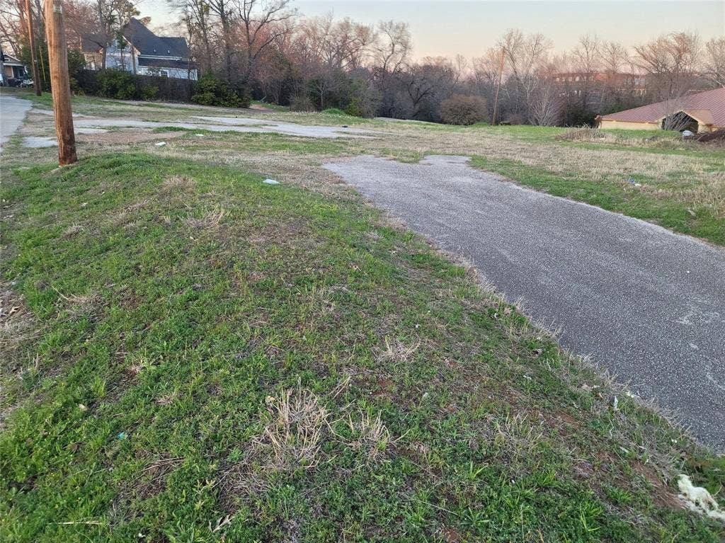 Expansive corner lot featuring paved road access and rolling topography