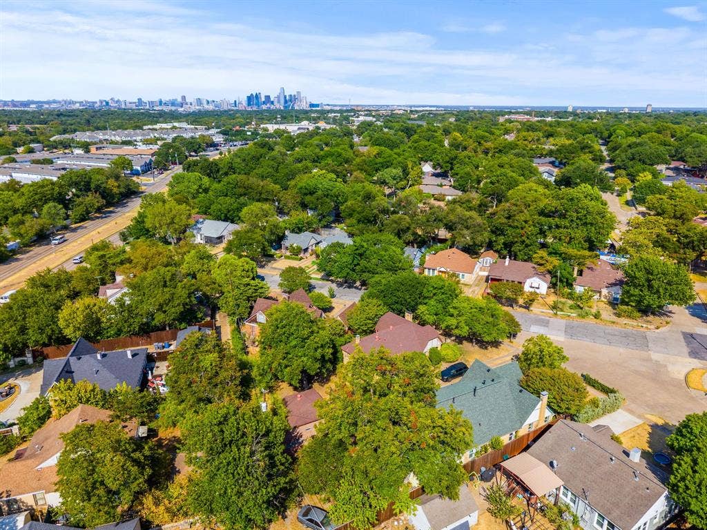2807 Cain Boulevard, Dallas, TX 75211 Residential neighborhood featuring mature trees and a distant city skyline