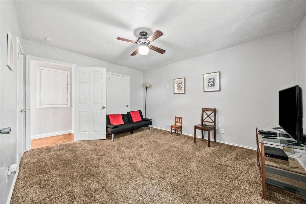 2807 Cain Boulevard, Dallas, TX 75211 Carpeted room with light grey walls, a ceiling fan, and white trim work