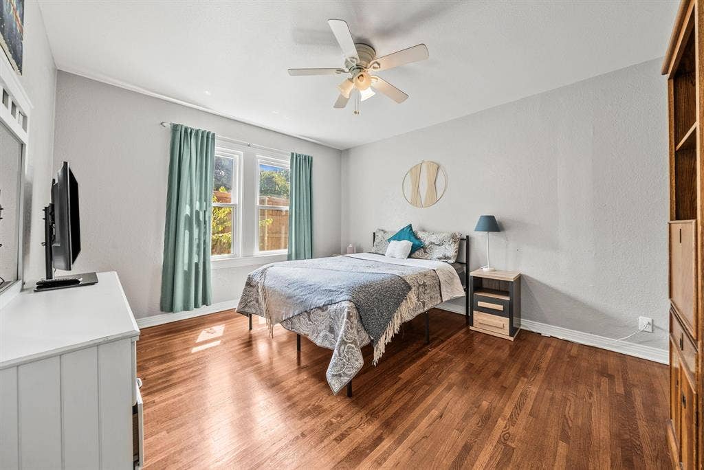 2807 Cain Boulevard, Dallas, TX 75211 Hardwood flooring, light gray walls, white trim, ceiling fan, and large windows