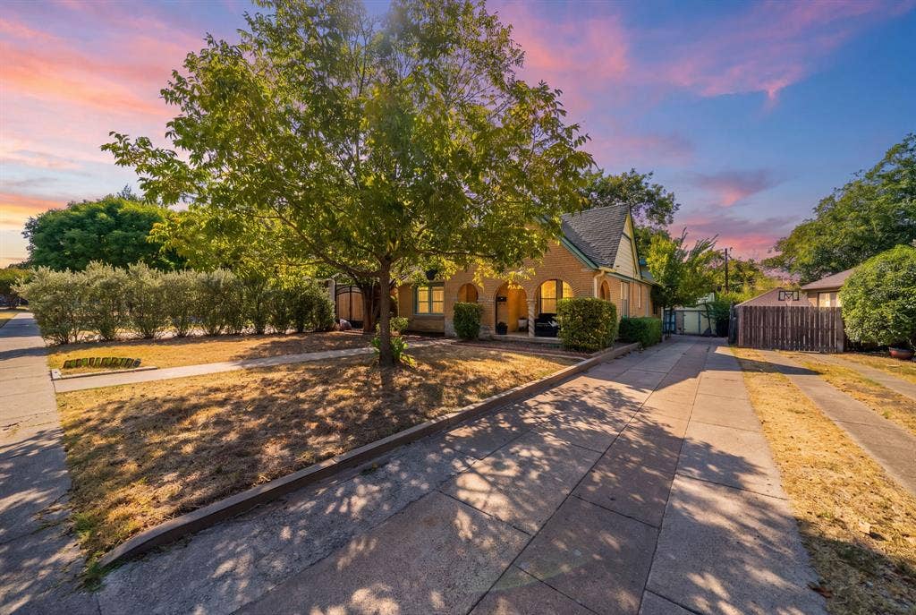 2807 Cain Boulevard, Dallas, TX 75211 Brick exterior with arched entryways, gabled roofline, and mature landscaping
