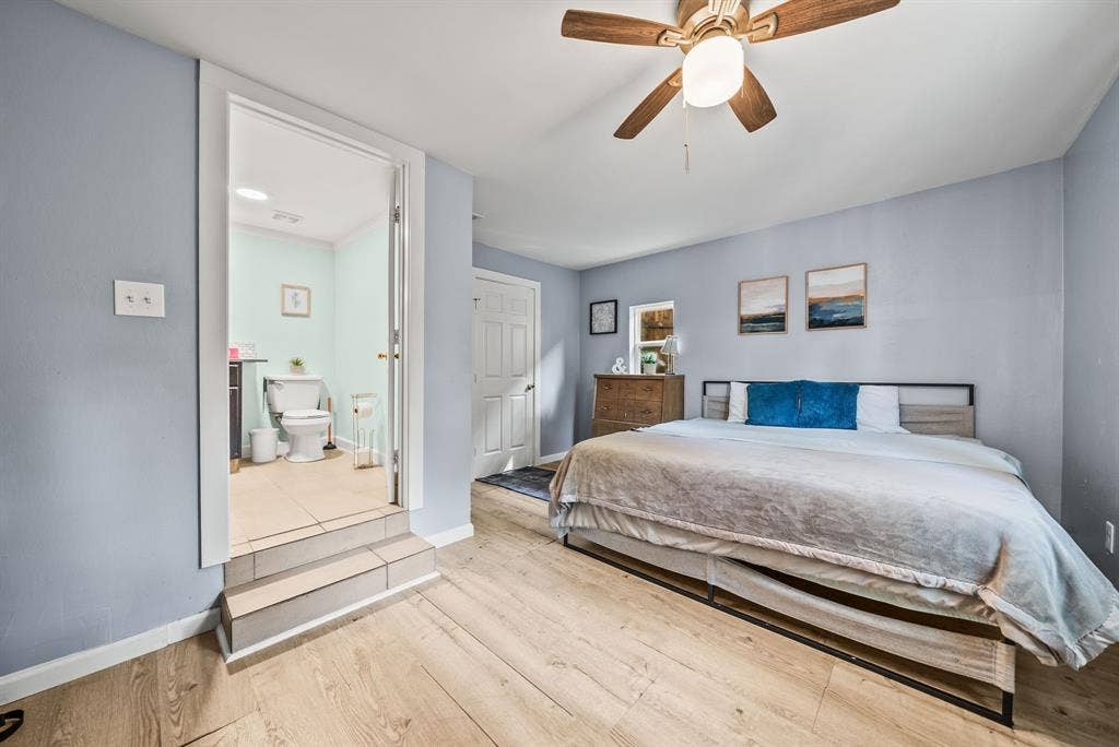 2807 Cain Boulevard, Dallas, TX 75211 Wood-finish flooring throughout, ceiling fan with integrated lighting, and a private attached bathroom featuring tile flooring