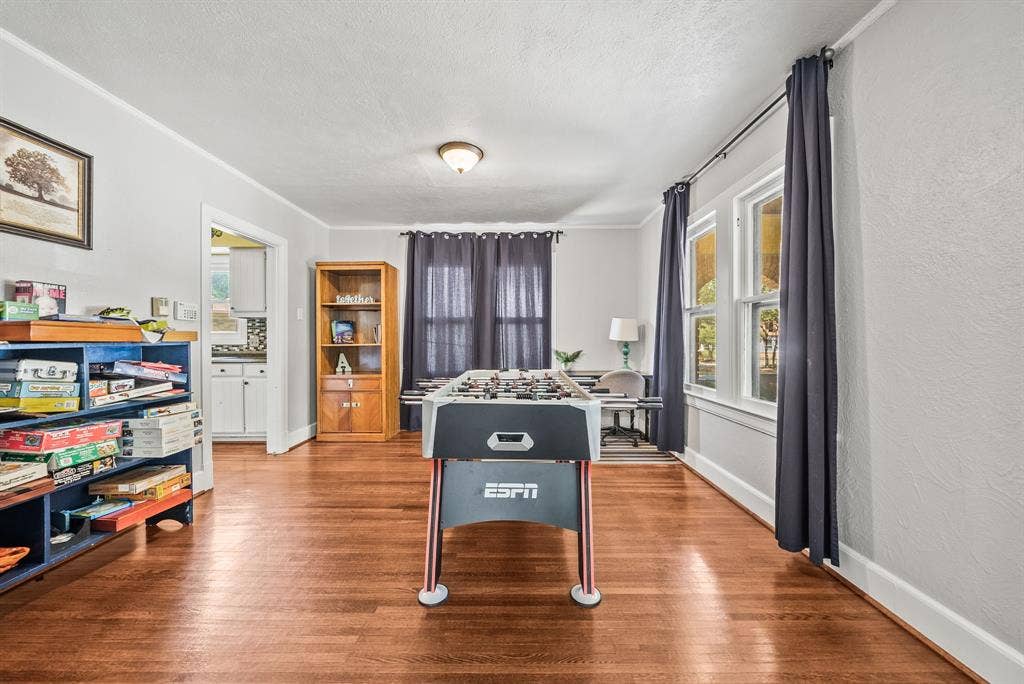 2807 Cain Boulevard, Dallas, TX 75211 Hardwood flooring throughout, multiple windows with natural light, recessed lighting, and an open doorway leading to an additional room