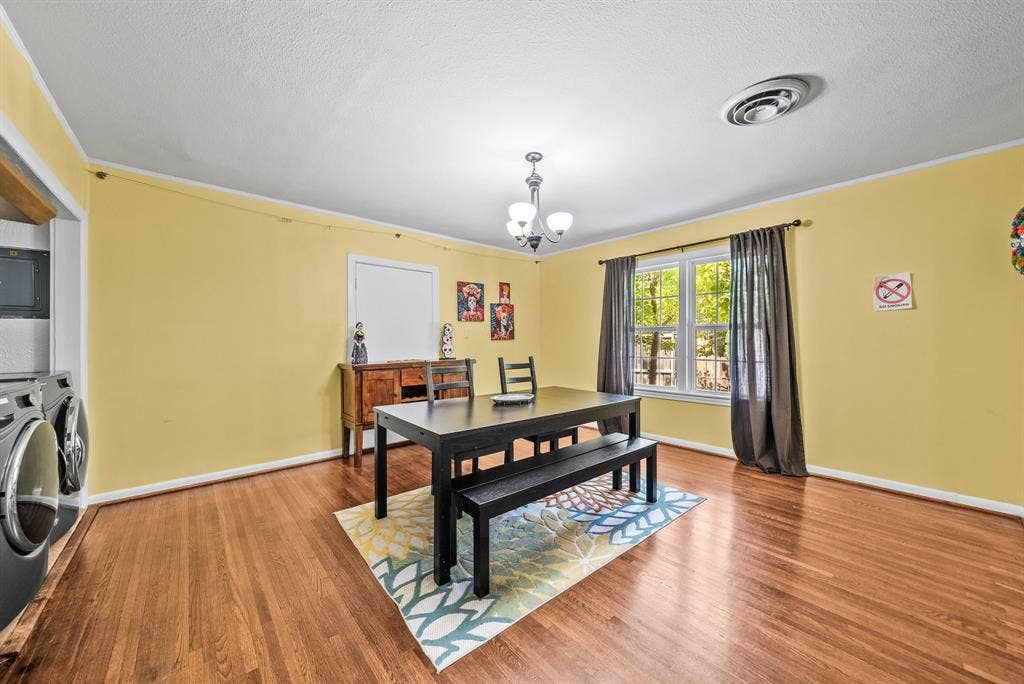 2807 Cain Boulevard, Dallas, TX 75211 Hardwood flooring extending throughout, window with natural light, and overhead lighting