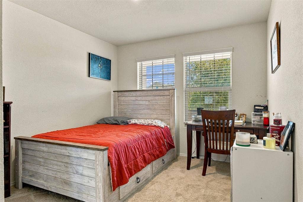 1516 Stonefield Drive, Anna, TX 75409 Neutral-toned interior space featuring light-colored wall-to-wall carpeting and two large windows with horizontal blinds