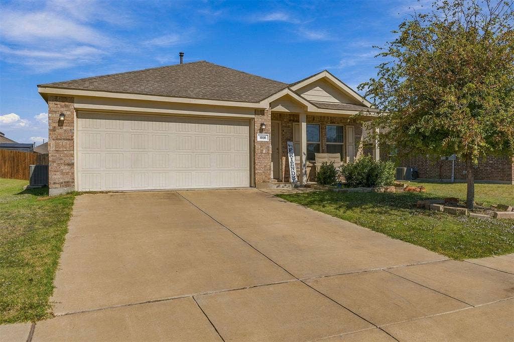 1516 Stonefield Drive, Anna, TX 75409 Attractive brick exterior and an attached two-car garage.